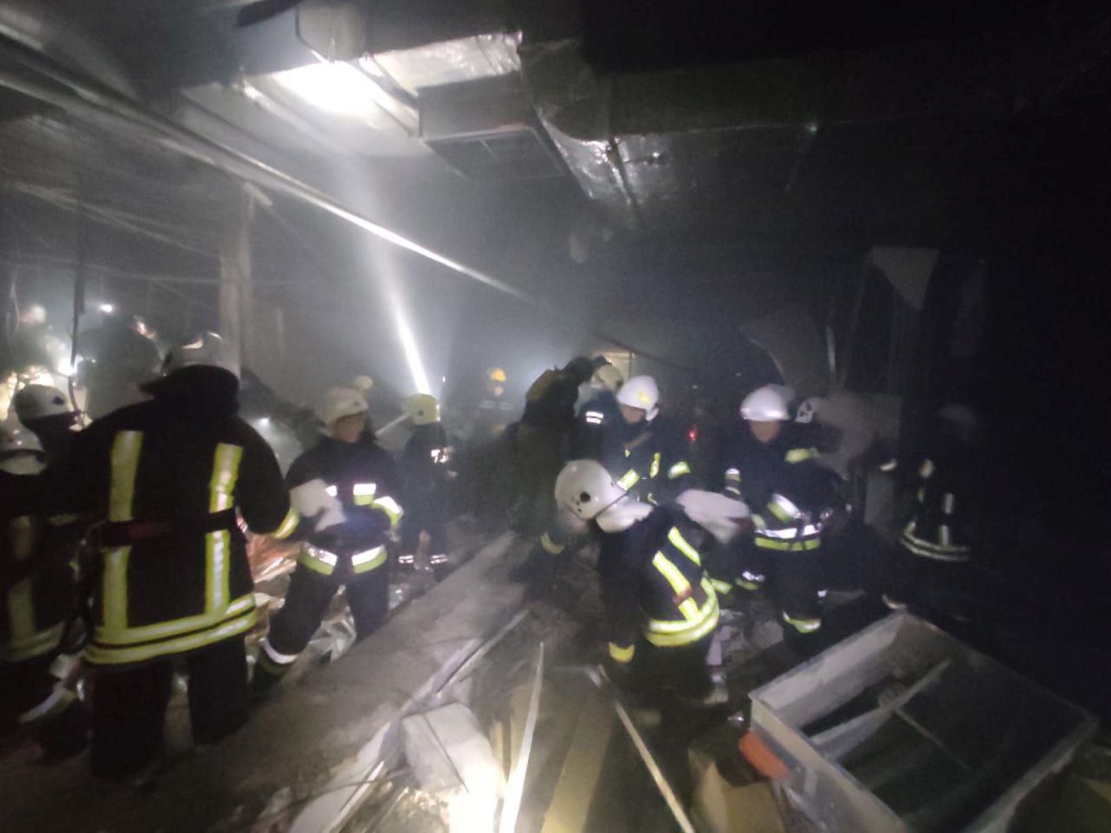 epa09840060 A handout photo released by the press service of the State Emergency Service of Ukraine on 21 March 2022 shows rescuers working at a damaged shopping center in the Podilskyi district of Kyiv (Kiev), Ukraine. According to a statement by the Ministry of Internal Affairs of Ukraine, the shopping center was damaged late 20 March as a result of Russian shelling.  EPA/STATE EMERGENCY SERVICE OF UKRAINE HANDOUT -- BEST QUALITY AVAILABLE -- MANDATORY CREDIT: STATE EMERGENCY SERVICE OF UKRAINE -- HANDOUT EDITORIAL USE ONLY/NO SALES