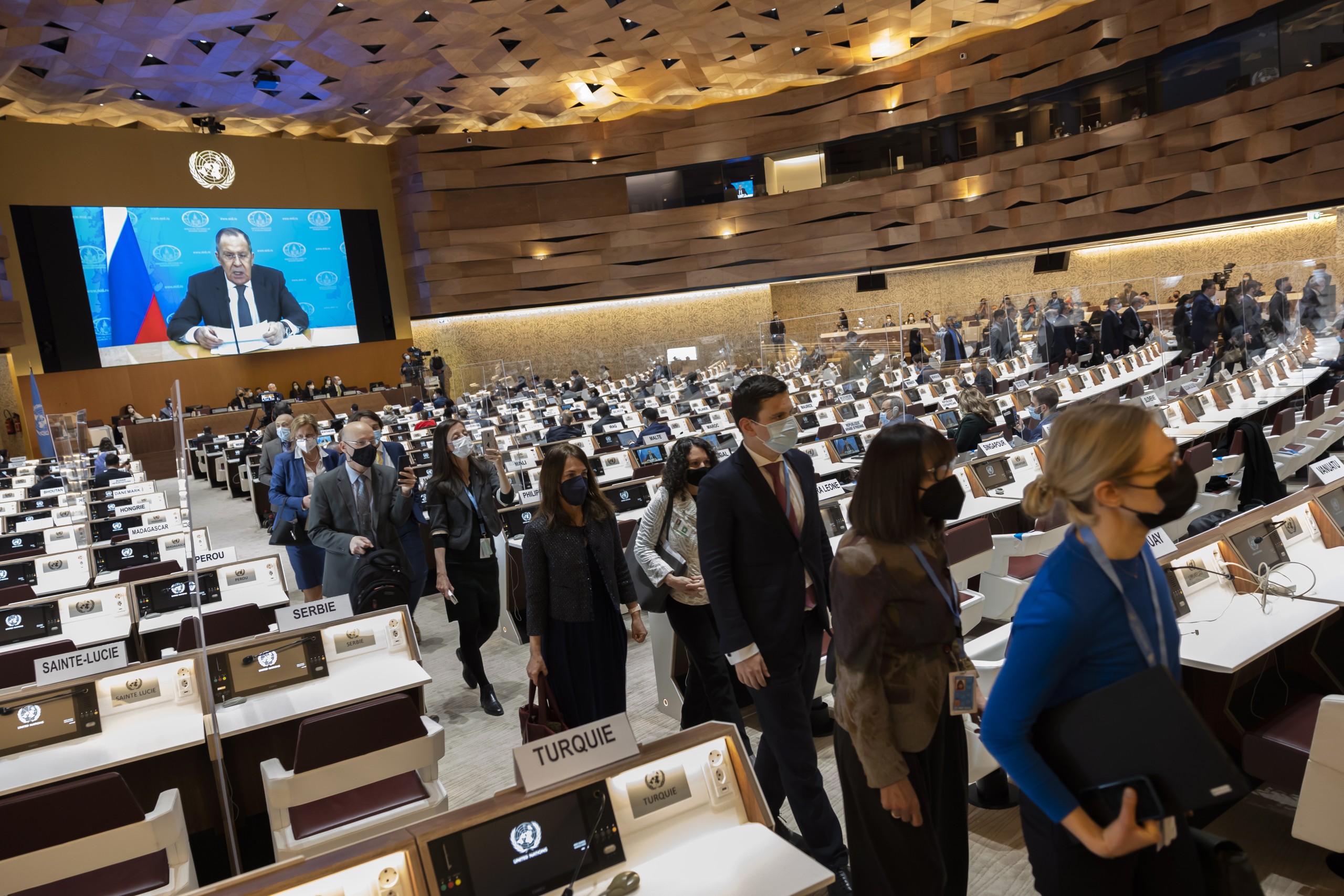 epa09840194 (FILE) - Ambassadors and diplomats walk out while Russia's foreign minister Sergei Lavrov (on screen) speaks during a pre-recorded video message at the 49th session of the UN Human Rights Council at the European headquarters of the United Nations in Geneva, Switzerland, 01 March 2022 (issued 21 March 2022). The diplomats got up and left the room when Sergei Lavrov's pre-recorded video message began to play, in protest against Russia's invasion of Ukraine. Since Russia invaded Ukraine one month ago on 24 February 2022, more than three million Ukrainians became refugees and two million are internally displaced, the United Nations said.  EPA/SALVATORE DI NOLFI / POOL  ATTENTION: This Image is part of a PHOTO SET