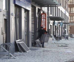 epa09840433 A local man cleans debris of windows of a residential building near the damaged shopping center that was targeted by a Russian attack in Kyiv, Ukraine, 21 March 2022. According to the emergency service in Kyiv (Kiev), at least six people died in the Russian bombing of the shopping center. Russian troops entered Ukraine on 24 February prompting the country's president to declare martial law and triggering a series of announcements by Western countries to impose severe economic sanctions on Russia.  EPA/SERGEY DOLZHENKO