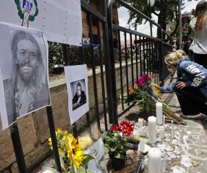 epa09851702 A fan of US rock band Foo Fighters ligths candles in honor of Taylor Hawkins outside Casa Medina hotel, in Bogota, Colombia, 26 March 2022. Drummer Taylor Hawkins, from Foo Fighters, died late 25 March in Bogota. No causes of death was given.  EPA/Mauricio Dueñas Castañeda
