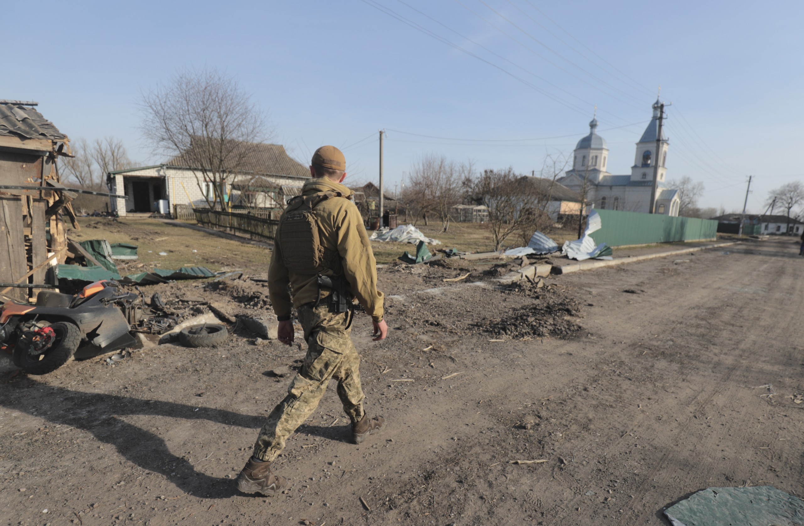 epa09856851 A Ukrainian soldier walks on a street after fighting, in an area now released from Russian troops, not far from Kyiv (Kiev), Ukraine, 28 March 2022. On 24 February, Russian troops entered Ukrainian territory in what the Russian president declared a 'special military operation', resulting in fighting and destruction in the country, a huge flow of refugees, and multiple sanctions against Russia.  EPA/STR