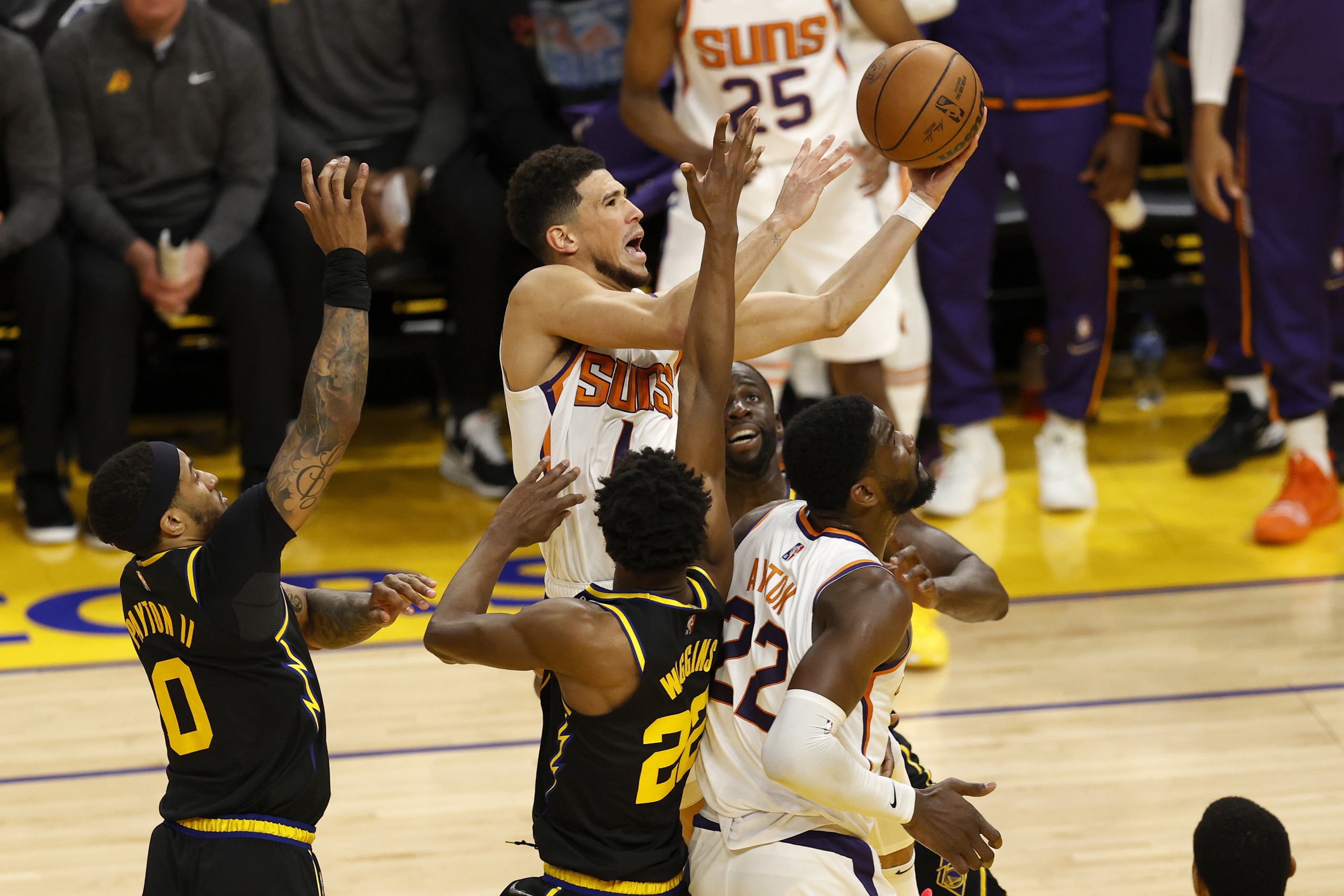 epa09861327 Phoenix Suns guard Devin Booker (C) goes to the basket for two points against the Golden State Warriors during the second half of their NBA game at Chase Center in San Francisco, California, USA, 30 March 2022.  EPA/JOHN G. MABANGLO SHUTTERSTOCK OUT
