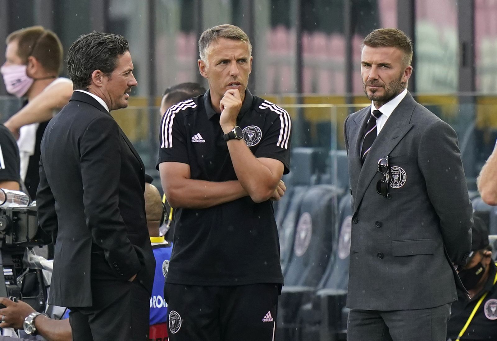 David Beckham, owner and president of soccer operations for Inter Miami, right, talks with head coach Phil Neville, center, and David Gardner, left, before an MLS soccer match between Inter Miami and CF Montréal, Wednesday, May 12, 2021, in Fort Lauderdale, Fla. (AP Photo/Lynne Sladky)