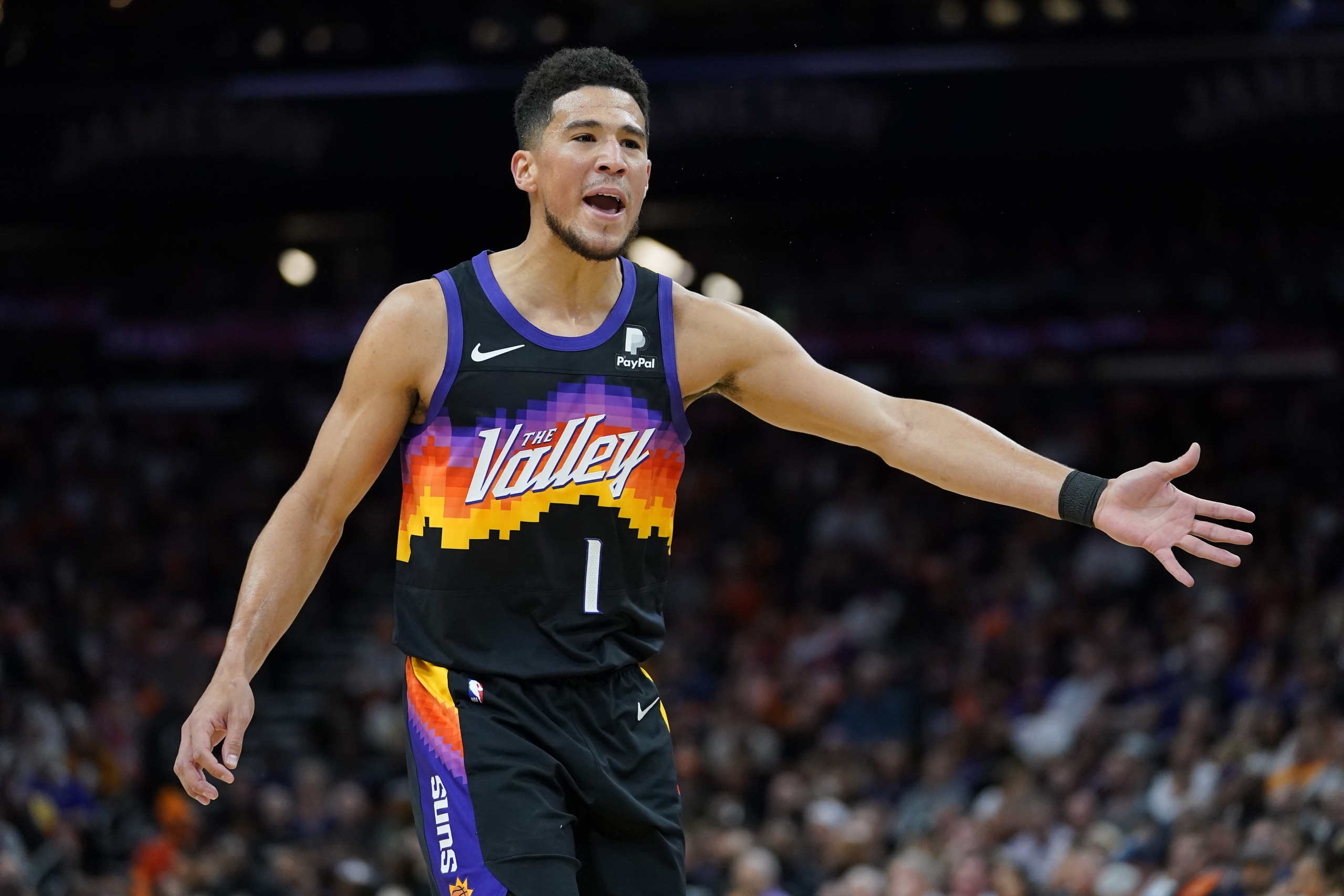 Phoenix Suns guard Devin Booker (1) looks for a call during the first half of Game 2 of an NBA basketball first-round playoff series against the New Orleans Pelicans, Tuesday, April 19, 2022, in Phoenix. (AP Photo/Matt York)