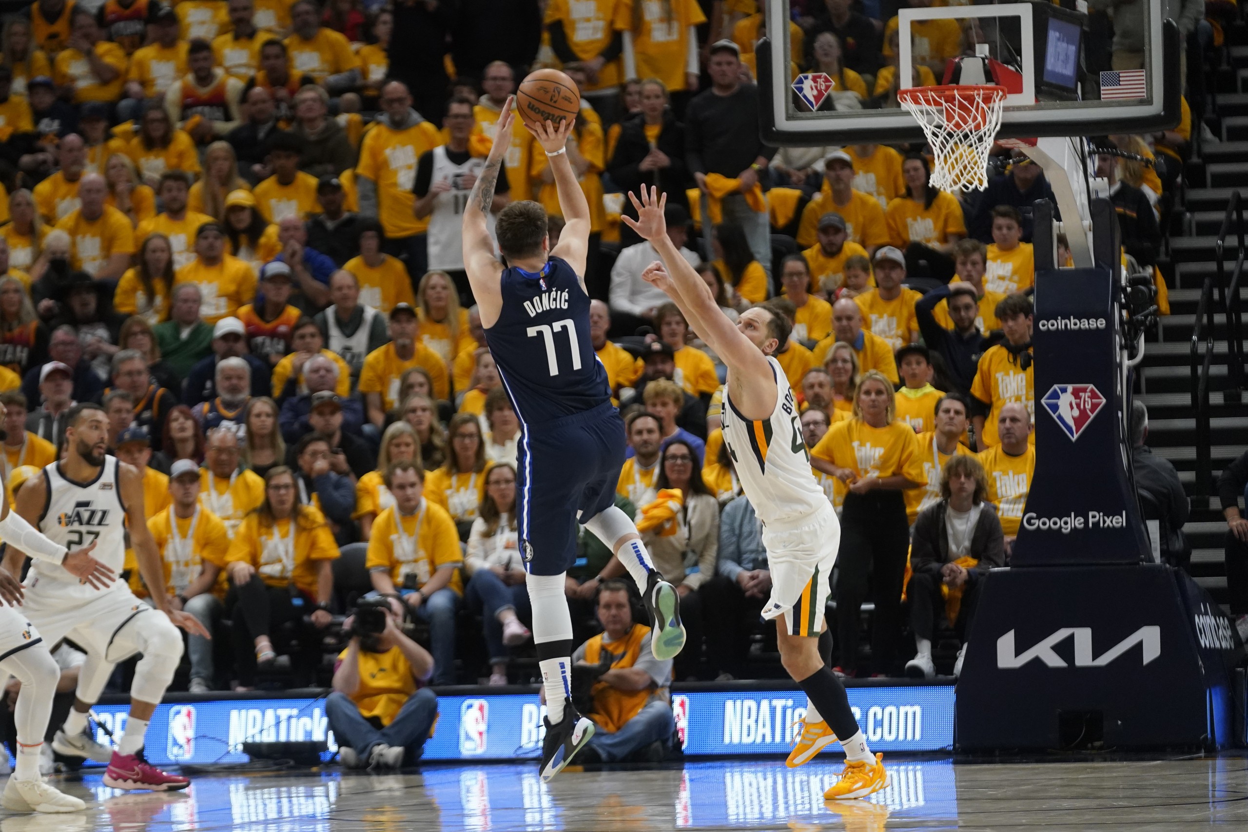 Dallas Mavericks guard Luka Doncic (77) shoots as Utah Jazz forward Bojan Bogdanovic, right, defends in the second half of Game 4 of an NBA basketball first-round playoff series, Saturday, April 23, 2022, in Salt Lake City. (AP Photo/Rick Bowmer)