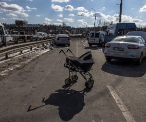 epaselect epa09815291 An abandoned stroller stands on a destroyed bridge as people flee from the frontline town of Irpin, Kyiv (Kiev) region, Ukraine, 10 March 2022. Thousands of residents are feeling Irpin and Bucha, as well as other settlements near Kyiv which were the most affected by the Russian army invasion.  EPA/ROMAN PILIPEY