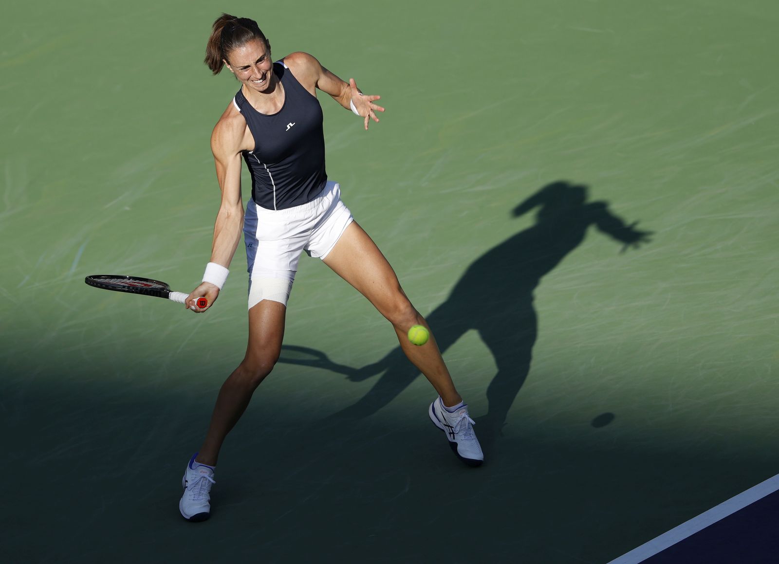 epa09830056 Petra Martic of Croatia in action against Simona Halep of Romania at the BNP Paribas Open tennis tournament at the Indian Wells Tennis Garden in Indian Wells, California, USA, 16 March 2022.  EPA/JOHN G MABANGLO