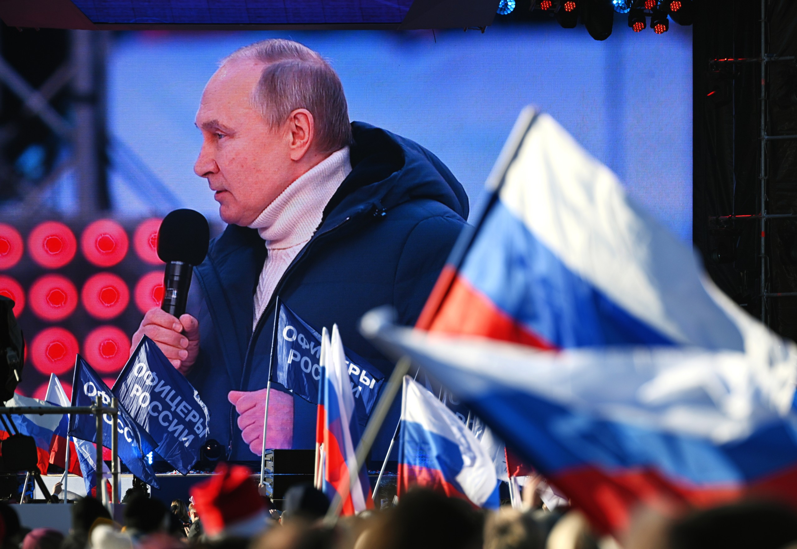 epa09833705 A screen shows Russian President Vladimir Putin delivering a speech during a concert marking the 8th anniversary of Crimea's reunification with Russia at the Luzhniki stadium in Moscow, Russia, 18 March 2022. Russia in 2014 annexed the Black Sea peninsula, shortly after Crimeans voted in a disputed referendum to secede from Ukraine.  EPA/VLADIMIR ASTAPKOVICH / SPUTNIK / POOL MANDATORY CREDIT