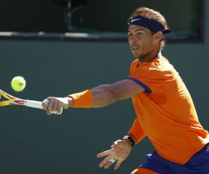 epa09839718 Rafael Nadal of Spain hits a return to Taylor Fritz of the US in the men's final match of the BNP Paribas Open tennis tournament at the Indian Wells Tennis Garden in Indian Wells, California, USA, 20 March 2022. The tournament runs from 07 through 20 March 2022.  EPA/JOHN G. MABANGLO
