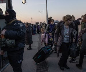 epa09850008 People who fled from the besieged by Russian military southeastern city of Mariupol and occupied Melitopol gather after arriving at the evacuation point in Zaporizhzhia, Ukraine, 25 March 2022. Hundreds of people were evacuated on 25 March from the southeastern cities of Mariupol and Melitopol and arrived in Ukraine's controlled area by buses and their own cars. Almost 100,000 residents remain trapped and live in 'inhuman conditions' without food and water in the ruined city of Mariupol, amid Russia's 'constant shelling', Ukrainian president Volodymyr Zelenskyy says.  EPA/ROMAN PILIPEY
