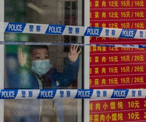 epa09857430 A quarantined boy looks through a shop window in a locked down restaurant, in Shanghai, China, 29 March 2022. On 29 March 2022, in China, there were 96 new locally transmitted COVID-19 cases and 4,381 asymptomatic infections, according to the National Health Commission. Shanghai city imposed a strict lockdown amid the COVID-19 resurgence. A complete lockdown hits the two biggest areas in the city, divided by the Huangpu River. East of the Huangpu River,  in the Pudong area the lockdown started on 28 March and lasts until 01 April, while in the western area, in Puxi, people will have a lockdown from 01 April to 05 April.  EPA/ALEX PLAVEVSKI