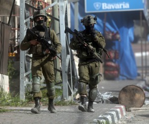 epa09860066 Israeli security forces search houses of Palestinians in the West Bank village of Yabad, near Jenin, 30 March 2022. Israeli troops have raided the village in a search operation. The alleged shooter who killed five Israelis in the central Israeli city of Bnei Brak, Diaa Hamarsheh, is from Yabad village. Hamarsheh, 27, was killed by the police on 29 March.  EPA/ALAA BADARNEH