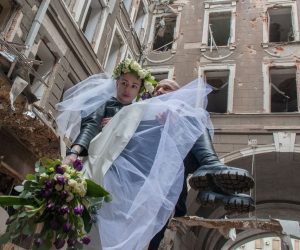 epa09867934 Ukrainian volunteers Anton and Nastia celebrate their wedding amid Russian invasion, in front of shelled building in Kharkiv, Ukraine, 03 April 2022. The city of Kharkiv, Ukraine's second-largest, has witnessed repeated airstrikes from Russian forces. On 24 February, Russian troops had entered Ukrainian territory in what the Russian president declared a 'special military operation', resulting in fighting and destruction in the country, a huge flow of refugees, and multiple sanctions against Russia.  EPA/VASILIY ZHLOBSKY