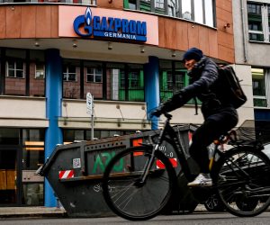 epa09872273 A cyclist passes by Gazprom headquarters in Berlin, Germany, 05 April 2022. German Federal Network Agency on 04 April announced that it has taken over control of Russian gas company German subsidiary Gazprom Germania. The Agency will be used as a trustee until 30 September to ensure proper management of the company.  EPA/FILIP SINGER