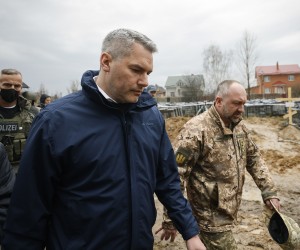 epa09880778 A handout photo made available by the Austrian Chancellery shows Austrian Chancellor Karl Nehammer looks on mass graves next to a church during a visit to Bucha, near Kyiv, Ukraine, 09 April 2022. Nehammer is on a one-day trip to show solidarity within the framework of Austria's neutrality, a statement from the chancellor's office says.  EPA/DRAGAN TATIC / AUSTRIAN CHANCELLERY / HANDOUT  HANDOUT EDITORIAL USE ONLY/NO SALES