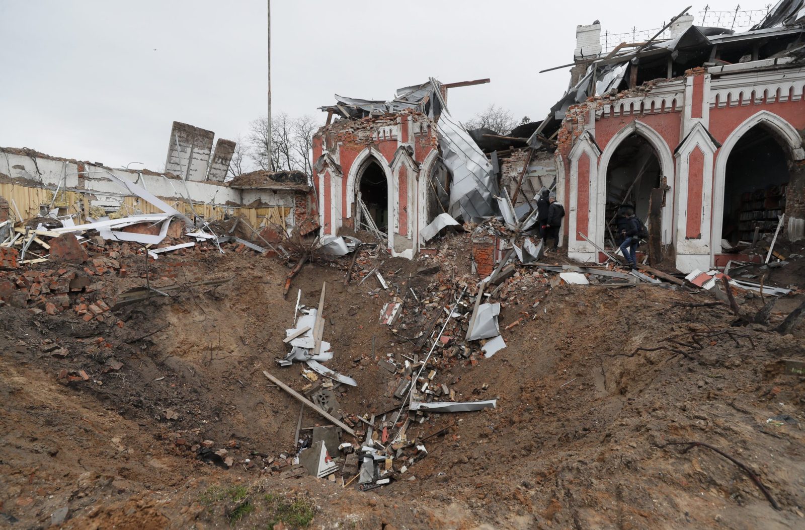 epa09881294 An impact crater from shelling in front of a shelled library in the city of Chernihiv, which was blocked by Russian troops for a long time, Ukraine, 09 April 2022. Some cities and villages had recently been recaptured by the Ukrainian army from Russian forces and now people try to restore normal life there. Russian troops entered Ukraine on 24 February resulting in fighting and destruction in the country and triggering a series of severe economic sanctions on Russia by Western countries.  EPA/SERGEY DOLZHENKO