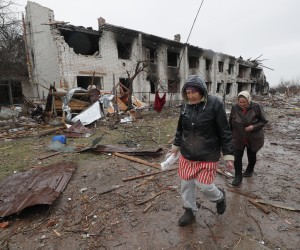 epa09881328 Locals walk by a shelled street on the outskirt of Chernihiv city which was blocked by Russian troops for a long time, Ukraine, 09 April 2022.  Some cities and villages had recently been recaptured by the Ukrainian army from Russian forces and now people try to restore normal life there. Russian troops entered Ukraine on 24 February resulting in fighting and destruction in the country and triggering a series of severe economic sanctions on Russia by Western countries.  EPA/SERGEY DOLZHENKO