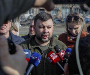 epa09884753 Head of the self-proclaimed Donetsk People's Republic Denis Pushilin (C) speaks with journalists at the place where, two weeks ago, an apartment building was destroyed as a result of a 'Uragan' missile hit, in Donetsk, Ukraine, 11 April 2022. In the self-proclaimed Donetsk People's Republic (DPR), 261 people died from 01 April to 07 April, the press service of the Commissioner for Human Rights in the republic reports. In total, 6,271 deaths have been registered in the DPR since the spring of 2014, including 96 children. On 24 February Russian troops had entered Ukrainian territory in what the Russian president declared a 'special military operation', resulting in fighting and destruction in the country, a huge flow of refugees, and multiple sanctions against Russia.  EPA/SERGEI ILNITSKY