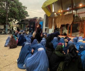 epa09885395 Afghan women waits for someone to charity bread in Kabul, Afghanistan, 11 April 2022 (issued 12 April 2022). The Taliban's return to power in August 2021 caused a certain disquiet among Afghan women, fearing that the rights gained over the last two decades during the Western-backed government would disappear again.  EPA/STRINGER