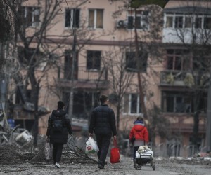 epa09886438 A picture taken during a visit to Mariupol organized by the Russian military shows local people walk on the Mira avenue in downtown of Mariupol, Ukraine, 12 April 2022. There is no water, electricity, gas or communications, and shops, pharmacies and hospitals are closed. Up to 70 percent of the housing stock of Mariupol was destroyed, said the newly appointed mayor of the city Konstantin Ivashchenko. Some 133,214 people, including two thousand people over the past day, left Mariupol through the gum corridor in the eastern direction, according to the head of the Russian National Defense Control Center. On 24 February Russian troops had entered Ukrainian territory in what the Russian president declared a 'special military operation', resulting in fighting and destruction in the country, a huge flow of refugees, and multiple sanctions against Russia.  EPA/SERGEI ILNITSKY