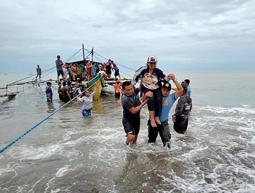 epa09887640 A handout photo made available by the Philippine Army (PA) - 14th Infantry Batallion shows a resident being evacuated to the town after her village was struck by landslide in the town of Abuyog, Leyte, Philippines, 13 April 2022. According to the National Disaster Risk Reduction and Management Council (NDRRMC), the death toll, on April 13, rose to 63 and over 100 people were injured while 27 are missing brought about by Typhoon Megi. Megi is the first weather disturbance to hit the country this year.  EPA/Philippine Army / HANDOUT BEST QUALITY AVAILABLE HANDOUT EDITORIAL USE ONLY/NO SALES