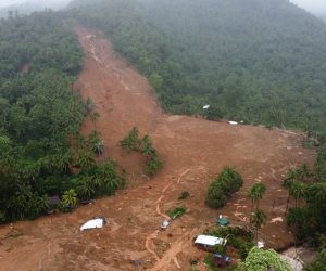 epa09887998 A photo taken with a drone shows a collapsed mountain side and buried houses in Bunga village, Baybay city, Leyte island, Philippines, 12 April 2022 (issued 13 April 2022). According to the National Disaster Risk Reduction and Management Council (NDRRMC), the death toll, on April 13, rose to 63 and over 100 people were injured while 27 are missing brought about by Typhoon Megi. Megi is the first weather disturbance to hit the country in 2022.  EPA/DELPHI ALLERA BEST QUALITY AVAILABLE