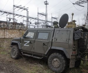 epa09888265 A picture taken during a visit to Shchastia organized by the Russian military shows a Russian serviceman guards on the entrance of the Luhansk Power Station in Luhansk region, in Shchastia, Luhansk region, Ukraine, 13 April 2022. Stopped by the Ukrainian side a few days before the start of the Russian special operation, the station provided electricity to more than a million people. The Ukrainian Armed Forces mined the object during the retreat, and some high-voltage power lines were damaged during the fighting. The station is a strategic and important energy facility of the self-proclaimed Luhansk People's Republic. After the start of operation of the station, it will be possible to start production at the metallurgical enterprises of the republic, which was stopped in 2014, when the station was cut off from the energy system of Lugansk. On 24 February Russian troops had entered Ukrainian territory in what the Russian president declared a 'special military operation', resulting in fighting and destruction in the country, a huge flow of refugees, and multiple sanctions against Russia.  EPA/SERGEI ILNITSKY