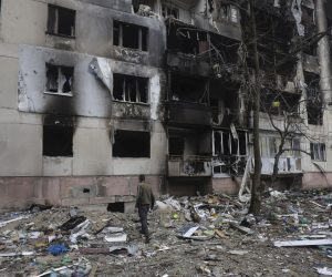epa09893604 A man walks past a residential building damaged during a shelling in Severodonetsk, North-West of Luhansk, Ukraine, 16 April 2022. Russian troops entered Ukraine on 24 February resulting in fighting and destruction in the country and triggering a series of severe international economic sanctions on Russia.  EPA/STR
