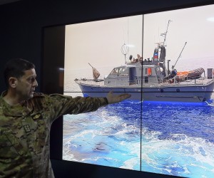 epa09906578 Commander of the Naval Forces, Colonel Naval Haitham Dnawy, points at a picture of a Lebanese navy ship as he speaks during a press conference explaining the circumstances of the boat that sank off the coast of Tripoli in North Lebanon, at the Naval Base in Beirut, Lebanon, 24 April 2022. According to Dnawy, 45 people were saved and 6 bodies were found, including that of a young girl, after a boat carrying nearly 60 illegal migrants out of Lebanon sank near the northern city of Tripoli. The boat capsized after its captain tried to evade Lebanese navy ships attempting to stop him which resulted in him crashing in a Lebanese navy ship.  EPA/WAEL HAMZEH