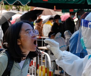 epa09911470 A woman undergoes a COVID-19 test in Beijing, China, 27 April 2022. Beijing continues its mass testing in 11 districts to over 20 million residents as the city recorded 34 COVID-19 cases, its highest since the Omicron variant was recorded on 22 April.  EPA/MARK R. CRISTINO