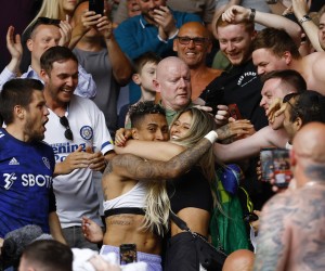 Soccer Football - Premier League - Brentford v Leeds United - Brentford Community Stadium, London, Britain - May 22, 2022 Leeds United's Raphinha celebrates with family and fans in the stands after the match as Leeds United avoid relegation from the Premier League Action Images via Reuters/Andrew Boyers EDITORIAL USE ONLY. No use with unauthorized audio, video, data, fixture lists, club/league logos or 'live' services. Online in-match use limited to 75 images, no video emulation. No use in betting, games or single club /league/player publications.  Please contact your account representative for further details.