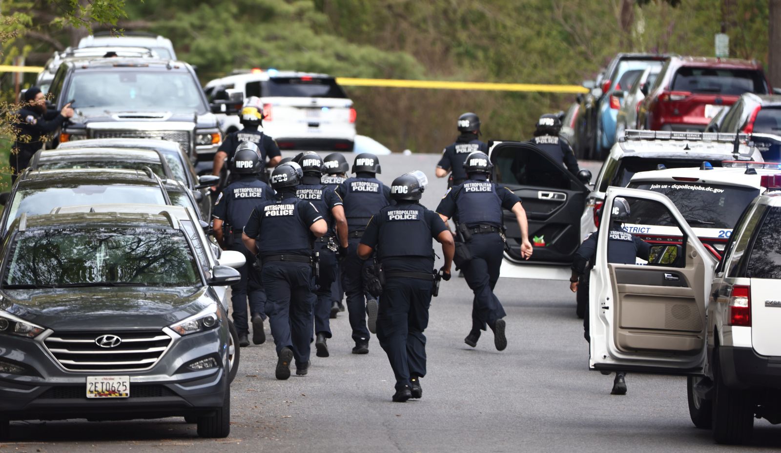 epa09903330 Washington DC Metropolitan Police and US Secret Service investigate at the scene of a reported shooting near the Edmund Burke School in Northwest Washington, DC, USA, 22 April 2022.  EPA/JIM LO SCALZO