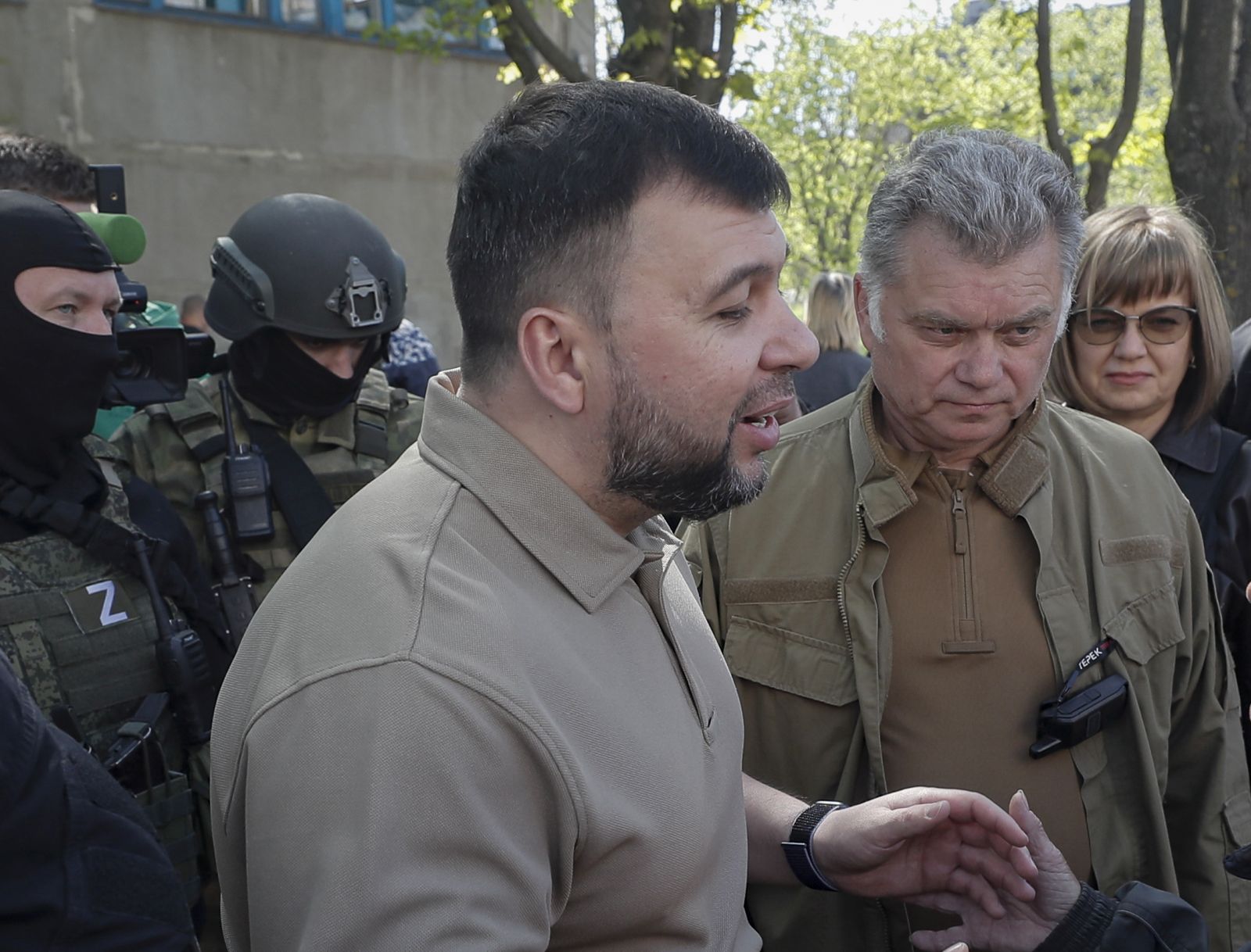 epa09917347 A picture taken during a visit to Luhansk organized by the Russian military shows Head of the self-proclaimed Donetsk People's Republic Denis Pushilin (L) and the new mayor of the city of Mariupol Konstantin Ivashchenko (C) speak with a local woman near the place where humanitarian aid is distributed in Mariupol, Ukraine, 29 April 2022. According to Eduard Basurin, spokesman of the self-proclaimed Donetsk People's Republic (DPR): 'after two months of continued hostility in the city, the main battles in Mariupol are over'. On 24 February Russian troops had entered Ukrainian territory in what the Russian president declared a 'special military operation', resulting in fighting and destruction in the country, a huge flow of refugees, and multiple sanctions against Russia.  EPA/SERGEI ILNITSKY