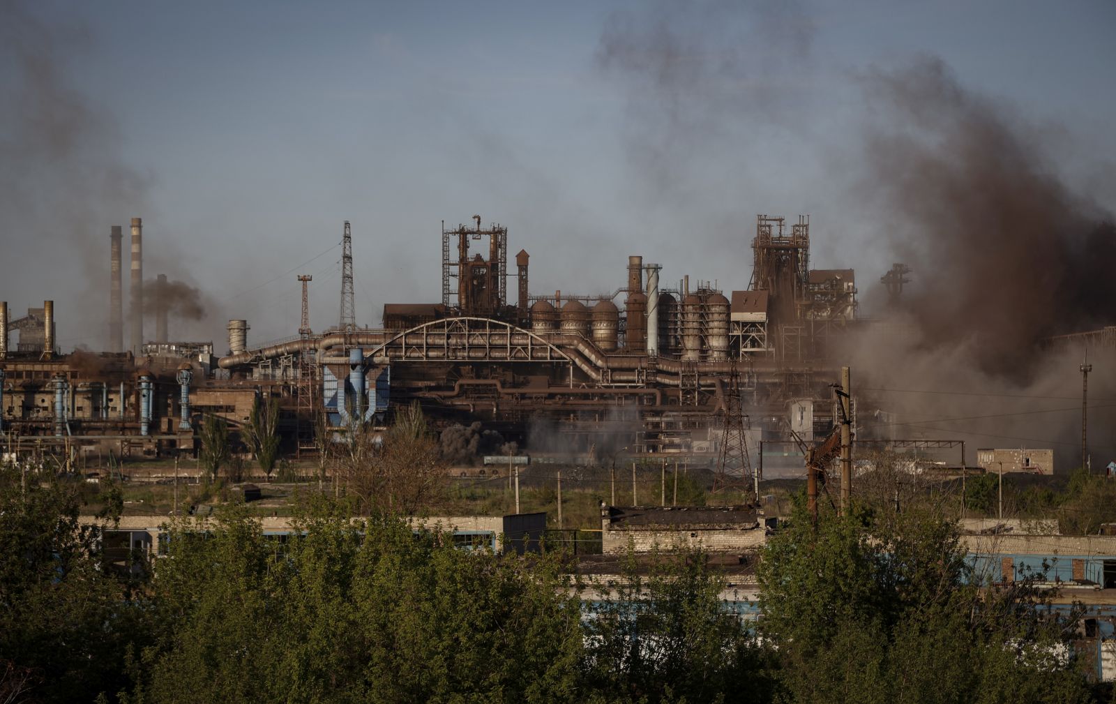 epa09932619 Smoke rises over Azovstal steel plant in Mariupol, Ukraine, 07 May 2022. According to the Interdepartmental Coordinating Headquarters of the Russian Federation for Humanitarian Response, 51 civilians, including 11 children, were evacuated from the Azovstal plant between 05 and 07 May. On 24 February, Russian troops had entered Ukrainian territory in what the Russian president declared a 'special military operation', resulting in fighting and destruction in the country. According to data released by the United Nations High Commission for the Refugees (UNHCR) on 05 May, over 5.7 million refugees have fled Ukraine seeking safety, protection and assistance in neighboring countries.  EPA/ALESSANDRO GUERRA