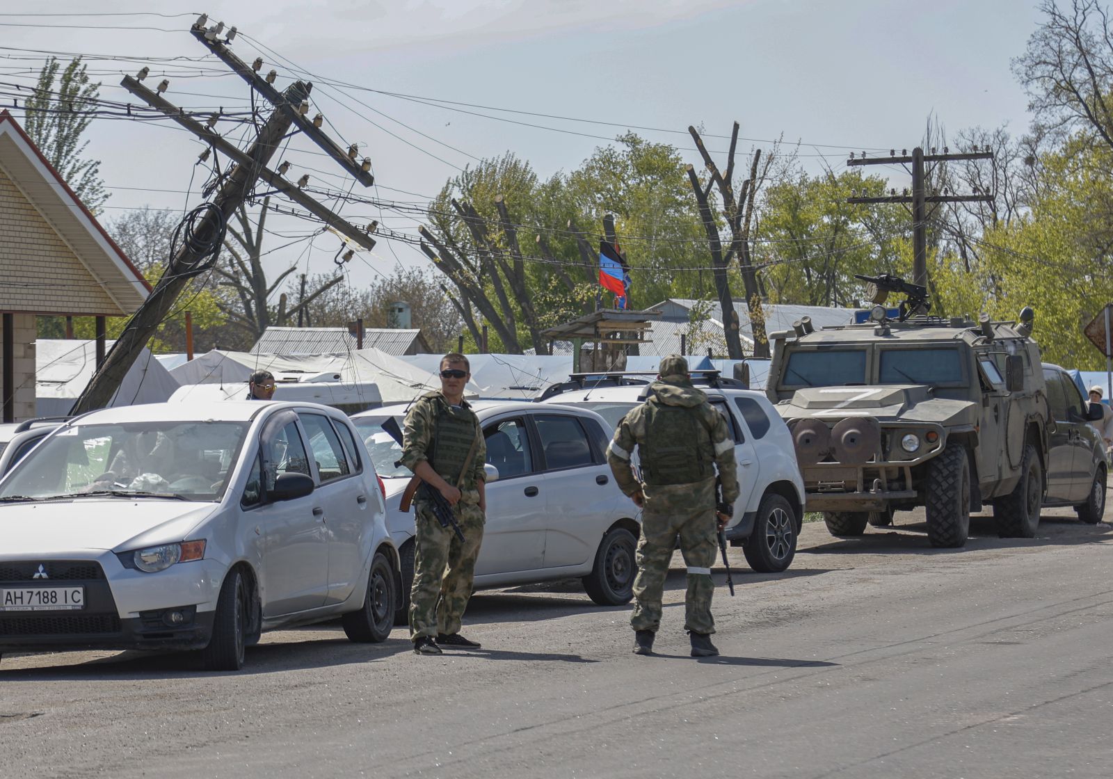 epa09932615 Russian servicemen stand guard at the temporary accommodation center for people was evacuated from Azovstal, in Bezimenoye village near Mariupol, Ukraine, 07 May 2022. According to the Interdepartmental Coordinating Headquarters of the Russian Federation for Humanitarian Response, 51 civilians, including 11 children, were evacuated from the Azovstal plant between 05 and 07 May. On 24 February, Russian troops had entered Ukrainian territory in what the Russian president declared a 'special military operation', resulting in fighting and destruction in the country. According to data released by the United Nations High Commission for the Refugees (UNHCR) on 05 May, over 5.7 million refugees have fled Ukraine seeking safety, protection and assistance in neighboring countries.  EPA/ALESSANDRO GUERRA