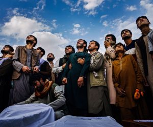 epa09936796 A handout photo made available by the Los Angeles Times of Marcus Yam's images on the fall of Afghanistan for which he won the  Pulitzer Prize for breaking news photography:

Mourners at a mass funeral look up and weep as the roar of jet engines drown out their wails in Kabul, Afghanistan, on Aug. 30, 2021. Fighter jets circled the hilltop cemetery where members of the Ahmadi family were burying 10 of their own - seven of them children - all victims of a U.S. drone strike. A full day before the U.S. military withdrawal approached its conclusion, death continued to haunt the war-torn country. The airstrike came in the wake of an airport bombing on Aug. 26 carried out by ISIS-K militants. The United States military claimed initially that it was targeting an alleged Islamic extremist who posed the threat of carrying out a similar attack. A month later, it reversed its position, but the Pentagon decided no American troops would be punished. Left to grieve and wonder, Emal Ahmadi could not understand how it could be that a family could die and no one be held accountable.  EPA/Marcus Yam / HANDOUT only to be used with reporting on 2022 Pulitzer Prize HANDOUT EDITORIAL USE ONLY/NO SALES/NO ARCHIVES