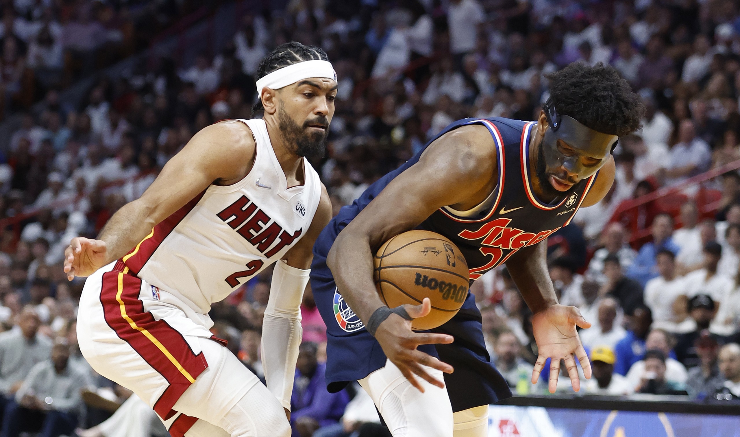 epa09939100 Philadelphia 76ers center Joel Embiid (R) is defended by Miami Heat guard Gabe Vincent (L) during the second half of the NBA Eastern Conference semifinals series between the Miami Heat and the Philadelphia 76ers at FTX Arena in Miami, Florida, USA, 10 May 2022.  EPA/RHONA WISE SHUTTERSTOCK OUT