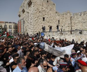 epa09944461 Mourners carry the coffin of slain American-Palestinian journalist Shireen Abu Akleh during a procession prior to her funeral in the Old City of Jerusalem, 13 May 2022. Al Jazeera journalist Shireen Abu Akleh was killed on 11 May 2022 during a raid by Israeli forces in the West Bank town of Jenin.  EPA/ATEF SAFADI