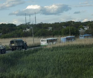 epa09953880 Russian militrary vehicles escort buses carrying Ukrainian servicemen that are being evacuated from the besieged Azovstal steel plant in Mariupol, Ukraine, 17 May 2022. A total of 265 Ukrainian militants, including 51 seriously wounded, have laid down arms and surrendered to Russian forces, the Russian Ministry of Defence said on 17 May 2022. Those in need of medical assistance were sent for treatment to a hospital in Novoazovsk, the ministry states further. Russian President Putin on 21 April 2022 ordered his Defence Minister to not storm but to blockade the plant where a number of Ukrainian fighters were holding out. On 24 February, Russian troops invaded Ukrainian territory starting a conflict that has provoked destruction and a humanitarian crisis. According to the UNHCR, more than six million refugees have fled Ukraine, and a further 7.7 million people have been displaced internally within Ukraine since.  EPA/ALESSANDRO GUERRA