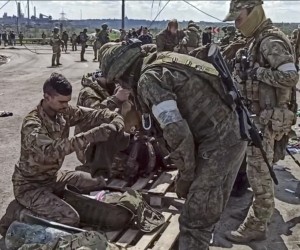 epa09962235 A still image taken from handout video made available on 21 May 2022 by the Russian Defence Ministry's press service shows Russian servicemen frisking Ukrainian servicemen evacuated from the besieged Azovstal steel plant in Mariupol, Ukraine, 20 May 2022 (issued 21 May 2022). The Chief spokesman of the Russian Defense Ministry, Major General Igor Konashenkov, said on 20 May that the Azofstal steel plant is now under full Russian army control. Russian troops entered Ukraine on 24 February 2022.  EPA/RUSSIAN DEFENCE MINISTRY PRESS SERVICE/HANDOUT BEST QUALITY AVAILABLE HANDOUT EDITORIAL USE ONLY/NO SALES