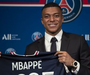 epa09969928 Paris Saint Germain's Kylian Mbappe poses with a PSG jersey after his press conference at the Parc des Princes stadium in Paris, France, 23 May 2022. Kylian Mbappe renewed his contract with French Ligue 1 soccer club Paris Saint-Germain until 2025.  EPA/Christophe Petit Tesson