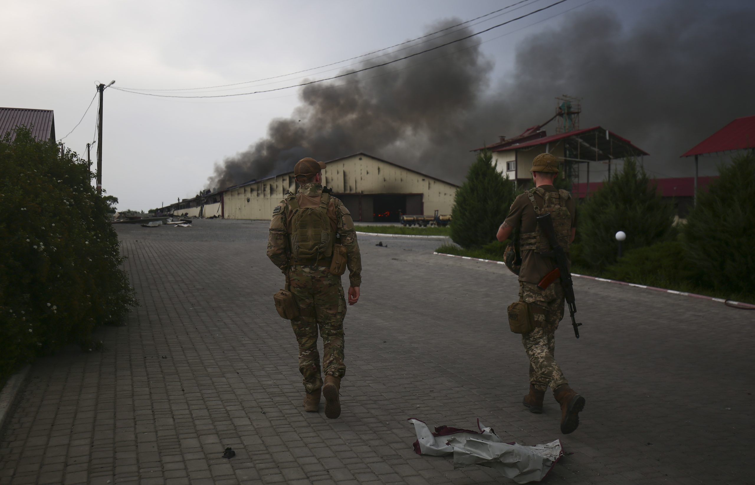 epa09988725 Ukrainian servicemen patrol the territory close to a front line near the small city of Bakhmut, Donetsk region, Ukraine, 31 May 2022. Russian troops entered Ukraine on 24 February resulting in fighting and destruction in the country and triggering a series of severe economic sanctions on Russia by Western countries.  EPA/STR
