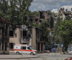 epa10009867 A picture taken during a visit to Mariupol organized by the Russian military shows an ambulance on a street in the cargo sea port of Mariupol, Ukraine, 12 June 2022. Russian Defense Minister Sergei Shoigu said the seaports of Mariupol and Berdyansk in Ukraine are operating normally and are ready to ship grain.  According to Shoigu, demining of the Mariupol seaport has been completed and it is functioning normally and has received the first cargo ships. Shoigu added ‘In Mariupol, water and electricity supply to residential areas are gradually being restored, streets are being cleared, the first social facilities have begun to function.’ On 24 February Russian troops entered Ukrainian territory starting a conflict that has provoked destruction and a humanitarian crisis. According to the UNHCR, more than six million refugees have fled Ukraine, and a further 7.7 million people have been displaced internally within Ukraine since.  EPA/SERGEI ILNITSKY