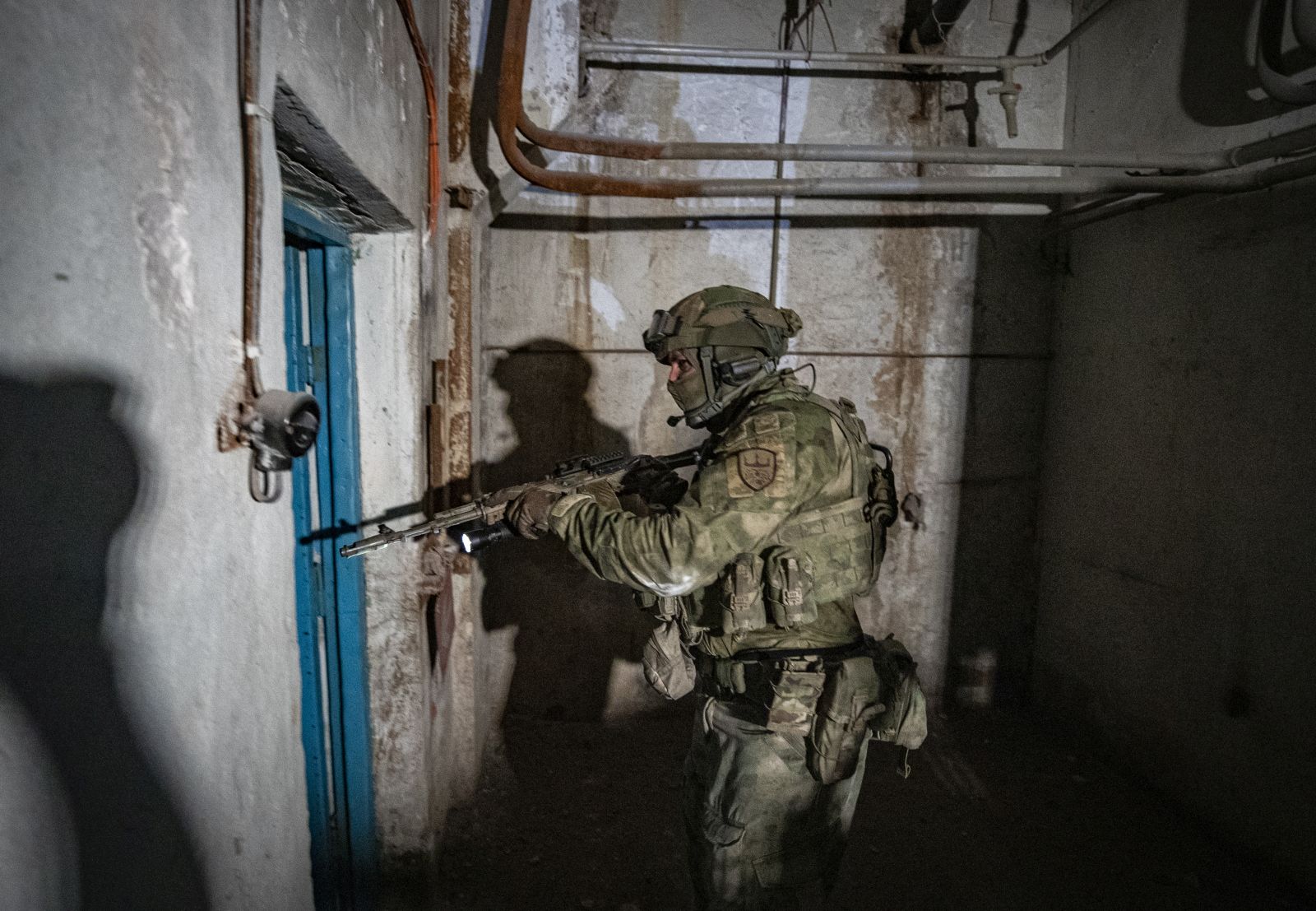 epa10011103 A picture taken during a visit to Mariupol organized by the Russian military shows an armed Russian serviceman inspecting the undergrounds of the Azovstal steel plant in Mariupol, eastern Ukraine, 13 June 2022. According to a statement by the Ukrainian Presidential Office on 06 June quoting President Zelensky, there may be more than 2,500 prisoners from the Azovstal plant being held captive by Russian forces. On 24 February Russian troops had entered Ukrainian territory in what the Russian president declared a 'special military operation', resulting in fighting, and multiple sanctions against Russia.  EPA/SERGEI ILNITSKY