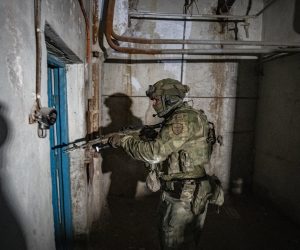 epa10011103 A picture taken during a visit to Mariupol organized by the Russian military shows an armed Russian serviceman inspecting the undergrounds of the Azovstal steel plant in Mariupol, eastern Ukraine, 13 June 2022. According to a statement by the Ukrainian Presidential Office on 06 June quoting President Zelensky, there may be more than 2,500 prisoners from the Azovstal plant being held captive by Russian forces. On 24 February Russian troops had entered Ukrainian territory in what the Russian president declared a 'special military operation', resulting in fighting, and multiple sanctions against Russia.  EPA/SERGEI ILNITSKY