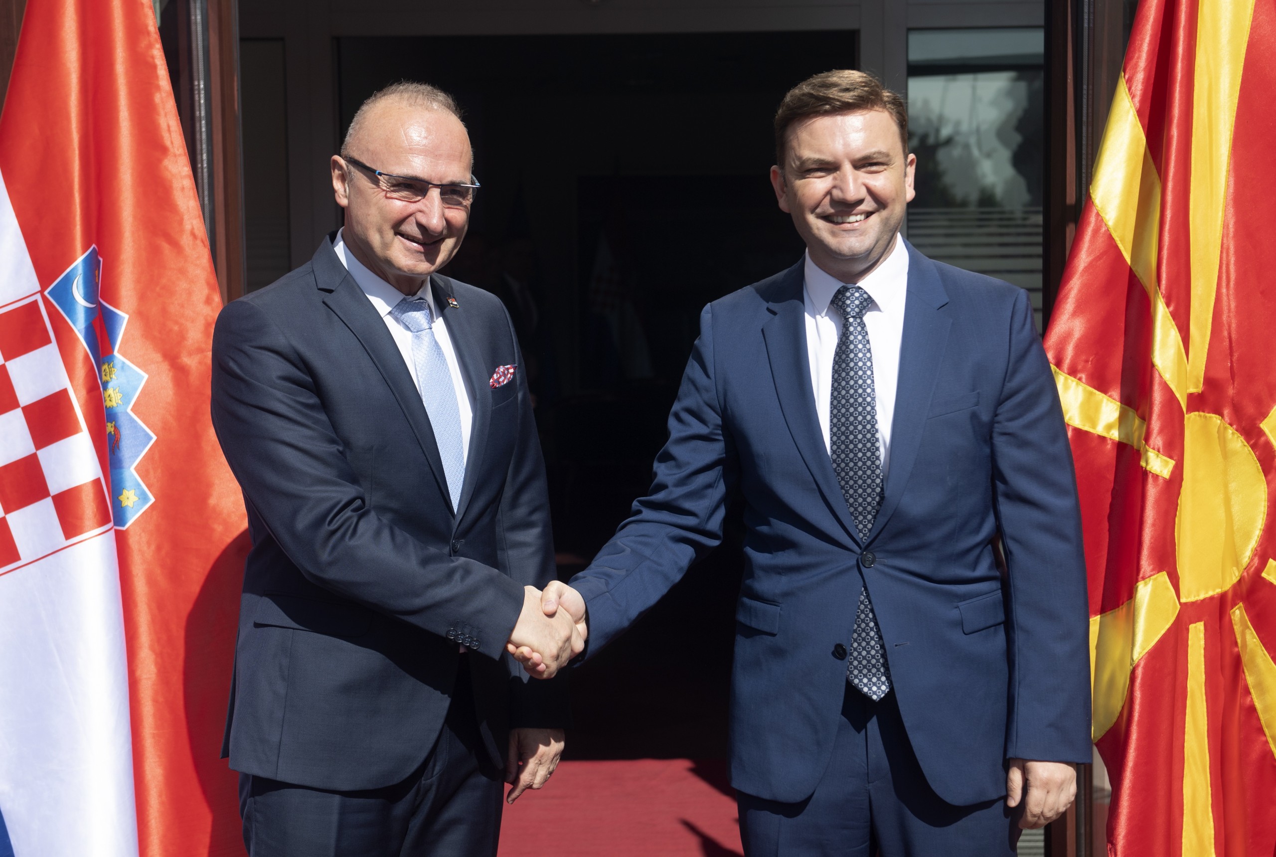 epa10014005 North Macedonia's Foreign Minister Bujar Osmani (R) welcomes his Croatian counterpart Gordan Grlic Radman (L) in Skopje, Republic of North Macedonia 15 June 2022. The Minister of Foreign and European Affairs of Croatia arrived in an official visit to North Macedonia.  EPA/GEORGI LICOVSKI