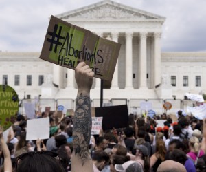 epa10032698 An abortion rights activist holds a sign that reads 'Abortion is healthcare' during a protest outside the Supreme Court in Washington, DC, USA, 24 June 2022. The US Supreme Court ruled on the Dobbs v Jackson WomenÕs Health Organization, overturning the 1973 case of Roe v Wade that guaranteed federal abortion rights.  EPA/MICHAEL REYNOLDS