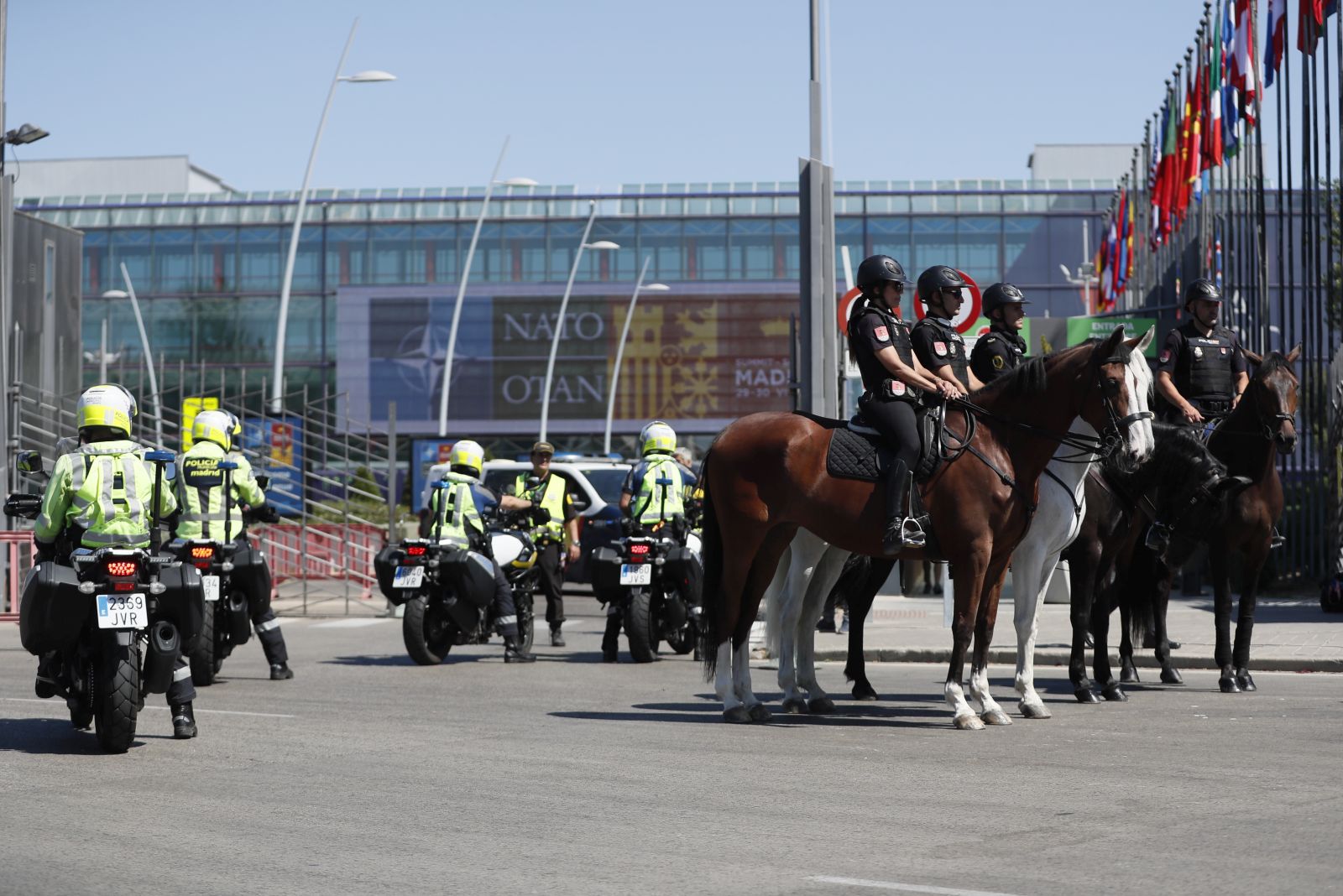epa10036310 Spanish police near the IFEMA center before the upcoming NATO summit in Madrid, Spain, 27 June 2022. The NATO Summit will be held from 28 to 30 June.  EPA/J.J.Guillen