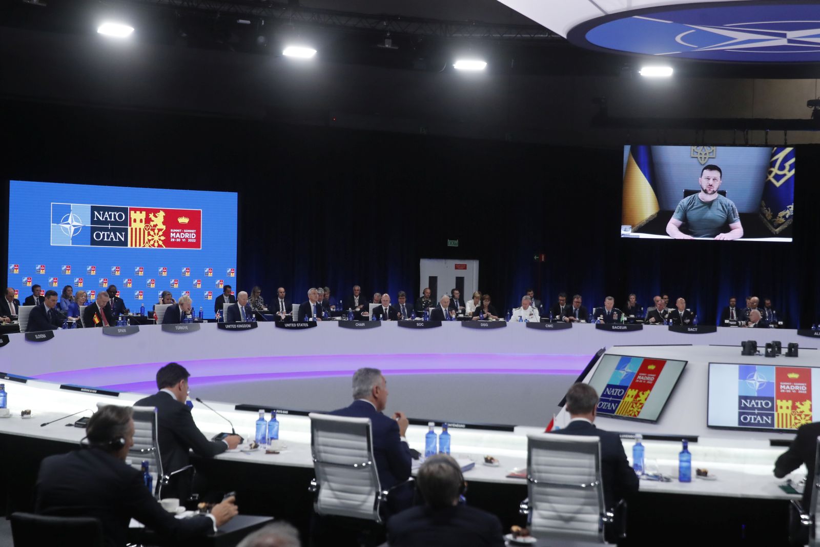 epa10040658 Ukrainian President Volodymyr Zelensky (on screen), delivers a speech as he attends by video conference a meeting during the first day of the NATO Summit at IFEMA Convention Center, in Madrid, Spain, 29 June 2022. Heads of State and Government of NATO's member countries and key partners are gathering in Madrid from 29 to 30 June to discuss security concerns like Russia's invasion of Ukraine and other challenges. Spain is hosting 2022 NATO Summit coinciding with the 40th anniversary of its accession to NATO.  EPA/Juan Carlos Hidalgo
