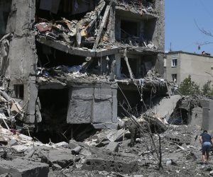 epa10046634 Locals regarda damaged residential building after shelling in the small city of Serhiivka near Odesa, southern Ukraine, 01 July 2022. At least 19 people were killed and 38 others injured, including six children, after overnight shelling hit a nine-story building and two holiday hotels in Serhiivka, Bilhorod-Dnistrovskyi district, Odesa region, the state emergency service said in a statement on 01 July.  EPA/STR